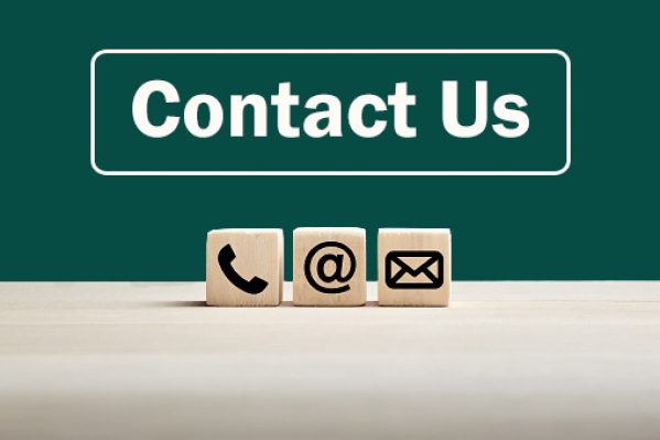 Phone and e-mail icons on wooden cubes with contact us text on blue background. Website page contact us or e-mail marketing concept.