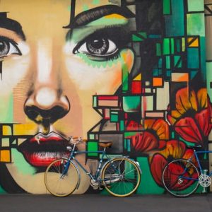 Bikes lean against wall painting